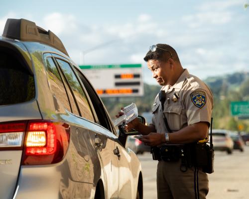 A CHP officer issuing a citation to a driver in vehicle pulled over from the I-680 Contra Costa express lanes.